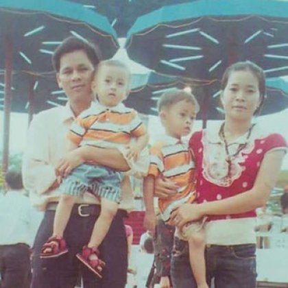 Anh with his parents and younger brother Duong in Vietnam. A photo taken in Vietnam of Tiep Tran and Giao Nguyen each holding their children.